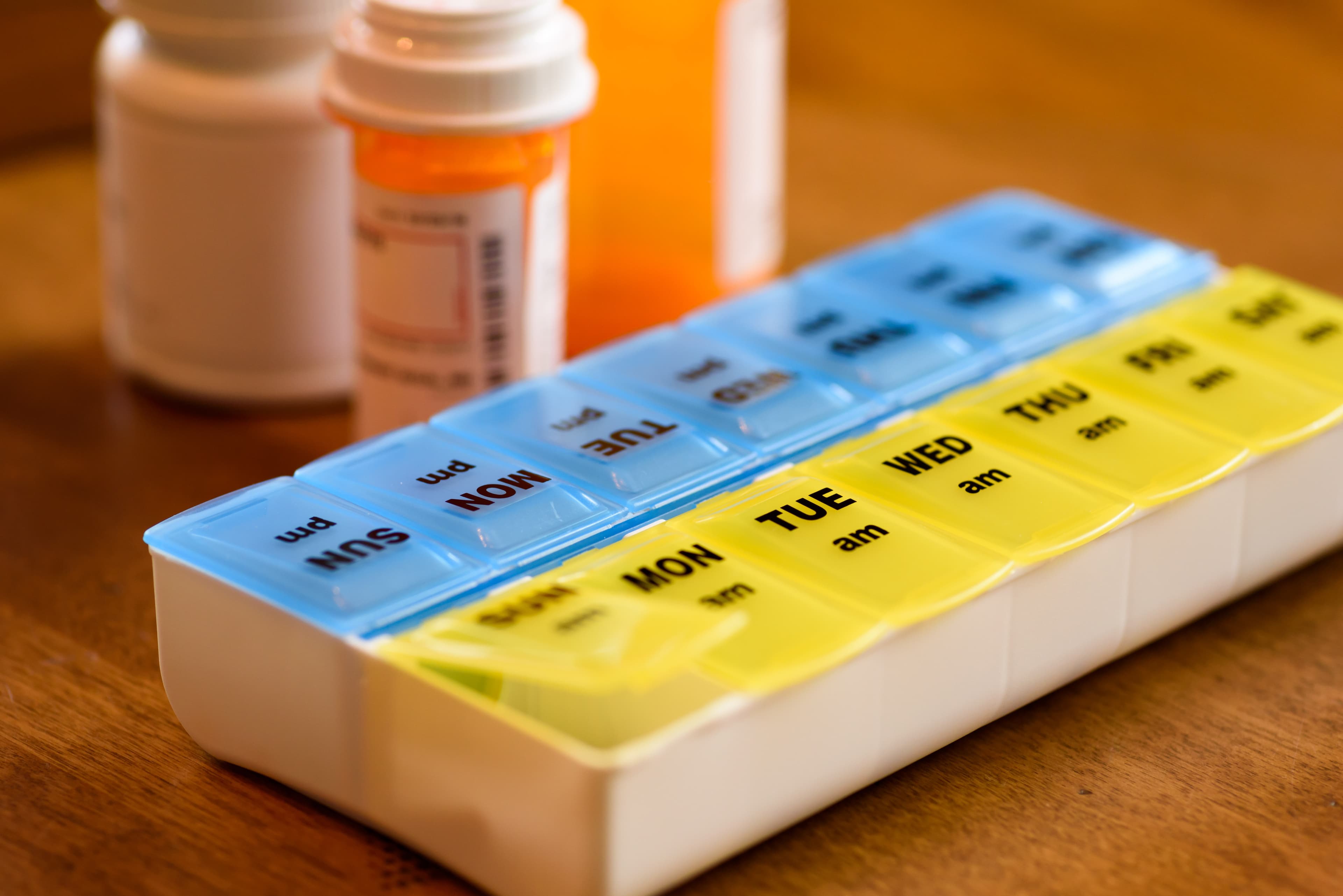 Organized weekly pill organizer representing consistent psychiatric medication management